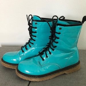 Turquoise boots with black laces.